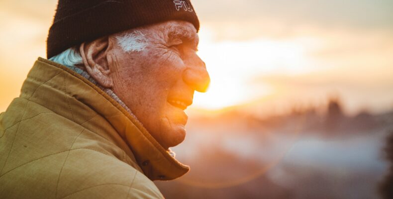 man wearing brown jacket and knit cap