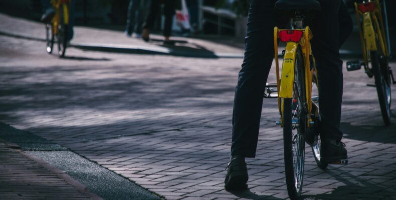 person riding on yellow bicycle during daytime